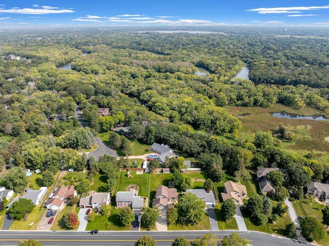 bird's eye view with a water view, a residential view, and a wooded view