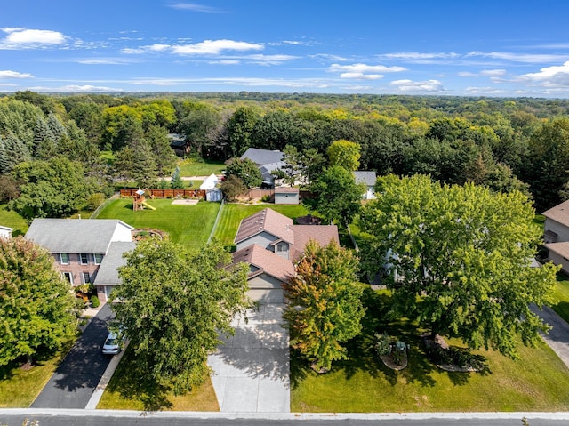 birds eye view of property featuring a residential view and a wooded view