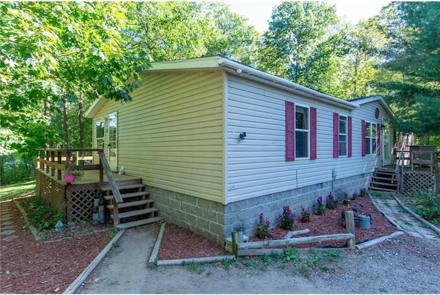 view of side of home with a wooden deck