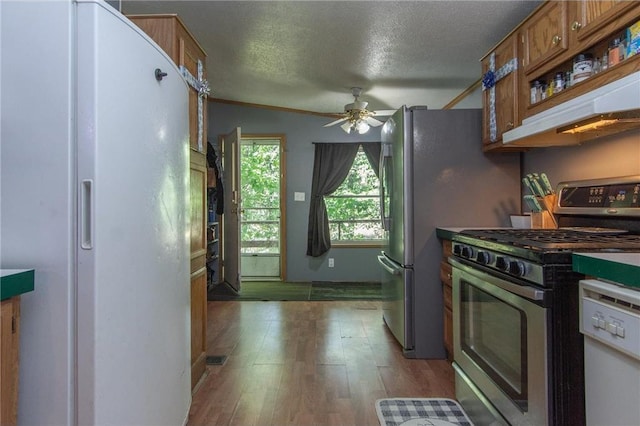 kitchen featuring a textured ceiling, white appliances, a ceiling fan, brown cabinets, and light wood finished floors