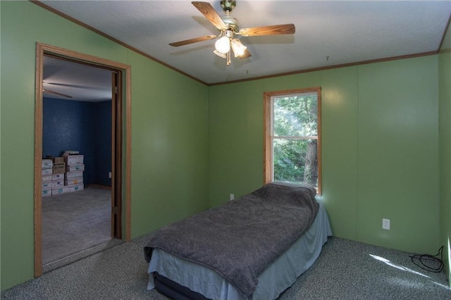 bedroom featuring carpet, a ceiling fan, and crown molding