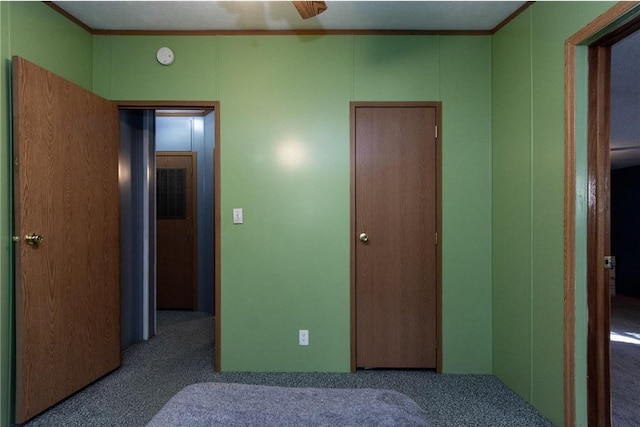 bedroom with ornamental molding and carpet flooring