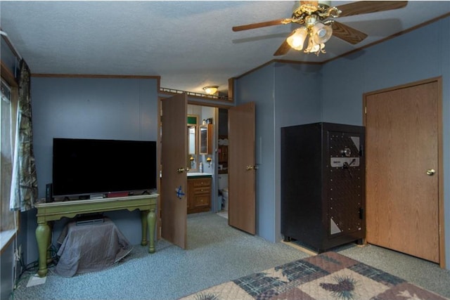 bedroom featuring carpet floors, ensuite bath, and ceiling fan