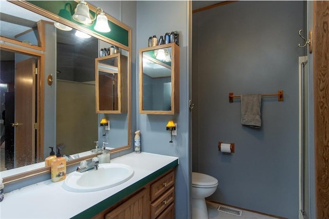 bathroom with toilet, visible vents, and vanity