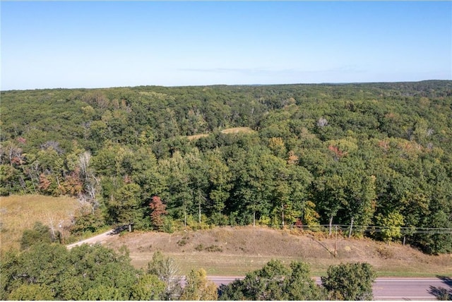 aerial view featuring a wooded view