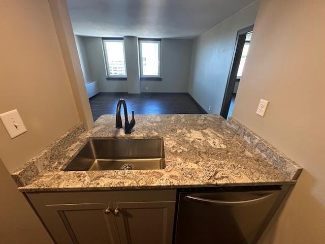 kitchen featuring a sink, light stone counters, and dishwasher