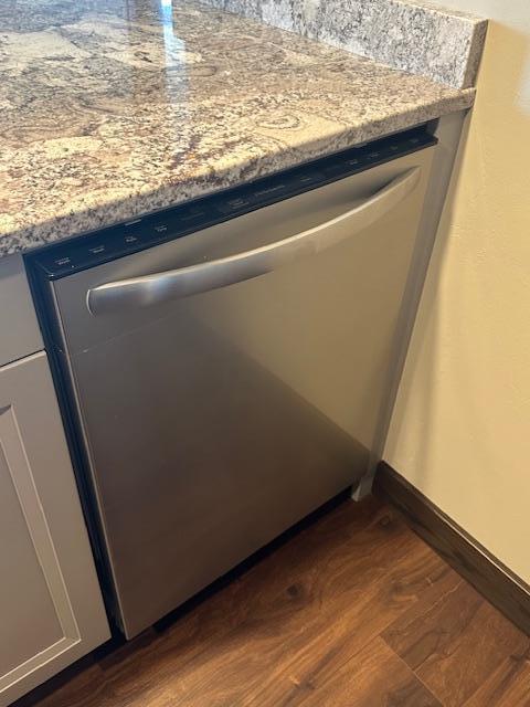 details with baseboards, dark wood finished floors, and dishwasher