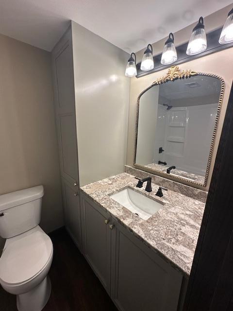 bathroom featuring toilet and vanity