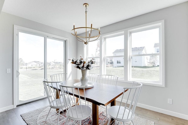 7310 Ambercrest Curv, Inver Grove Heights, MN 55077 - dining area with a chandelier, plenty of natural light, and baseboards