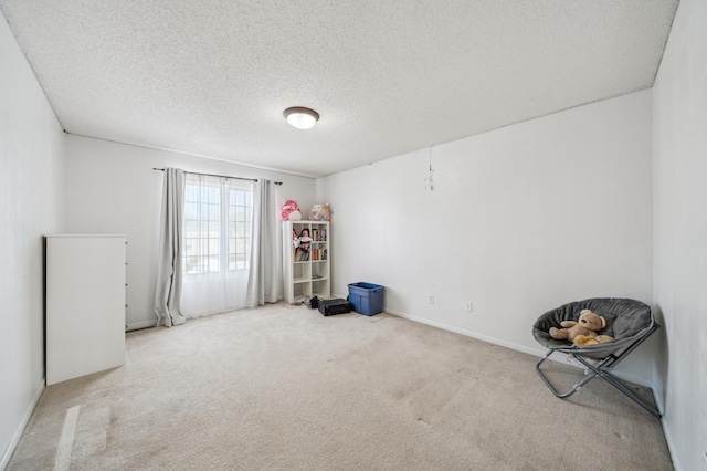 carpeted spare room with a textured ceiling