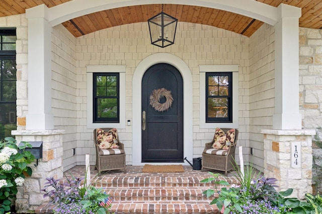 property entrance featuring stone siding