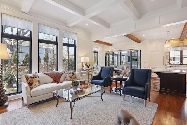 living area with beamed ceiling, dark wood-style flooring, coffered ceiling, and a chandelier