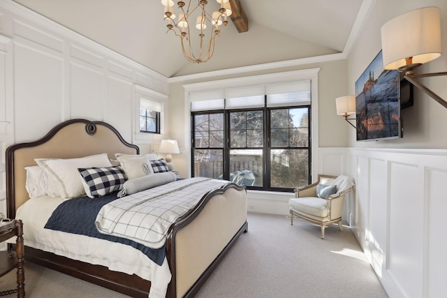 carpeted bedroom with a wainscoted wall, a chandelier, vaulted ceiling with beams, and a decorative wall