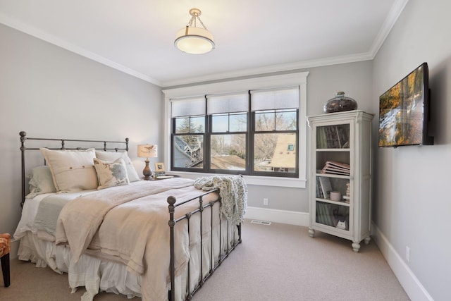 bedroom with crown molding, baseboards, and light carpet