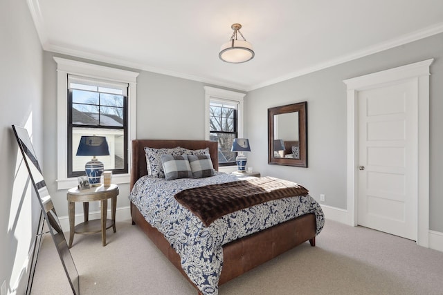 bedroom with ornamental molding, baseboards, and carpet floors