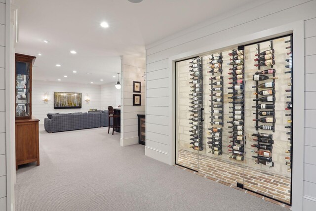 wine room with recessed lighting and carpet