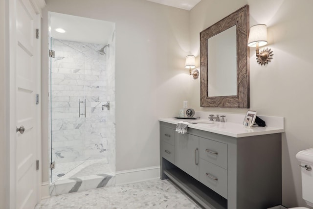 bathroom with baseboards, toilet, a stall shower, and vanity