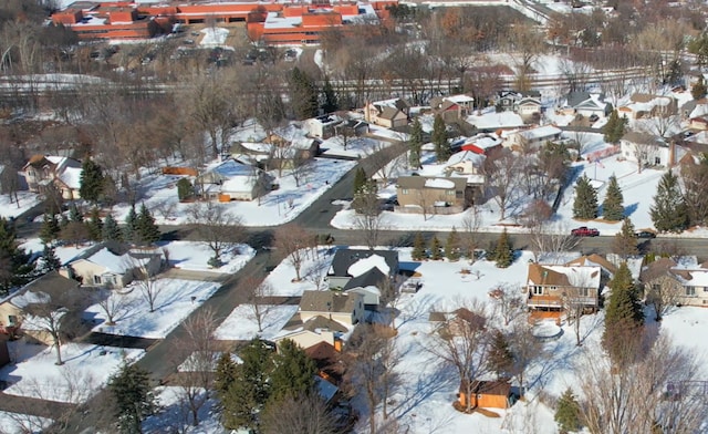 snowy aerial view with a residential view