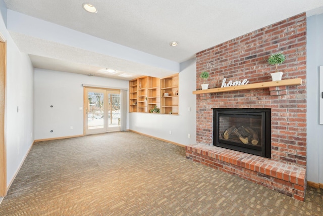 unfurnished living room featuring baseboards, carpet floors, and a fireplace