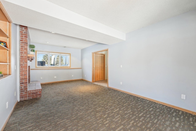 unfurnished living room with baseboards, carpet, and a textured ceiling