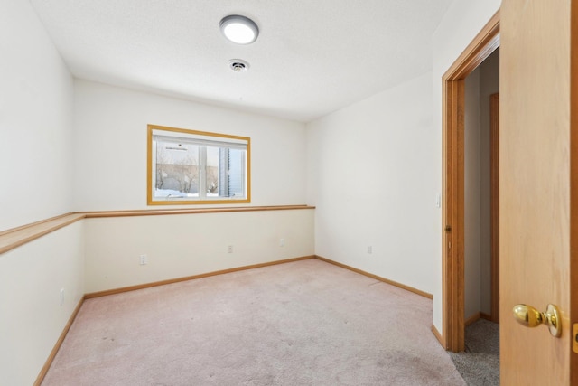 unfurnished room featuring visible vents, baseboards, and carpet floors