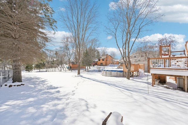 snowy yard with a covered pool