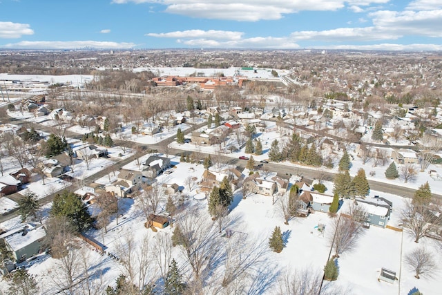 snowy aerial view featuring a residential view