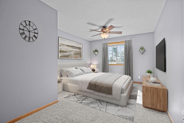 carpeted bedroom with baseboards, a textured ceiling, and a ceiling fan