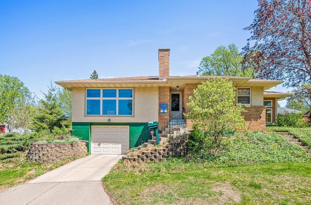 1938 Sheridan Ave, Saint Paul, MN 55116 - view of front of property with an attached garage, driveway, a chimney, brick siding, and stucco siding