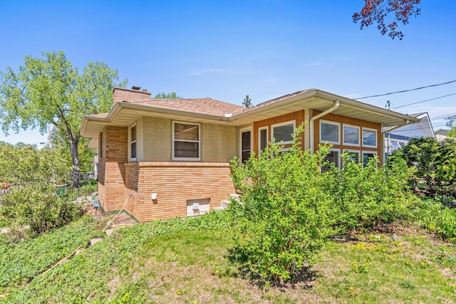 1938 Sheridan Ave, Saint Paul, MN 55116 - view of property exterior featuring a chimney, brick siding, and stucco siding