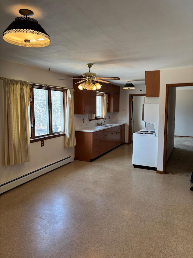 kitchen featuring light countertops, brown cabinets, baseboard heating, and white electric stove