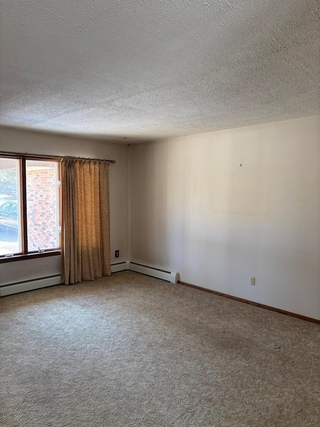 carpeted empty room with a textured ceiling, a baseboard heating unit, and baseboards