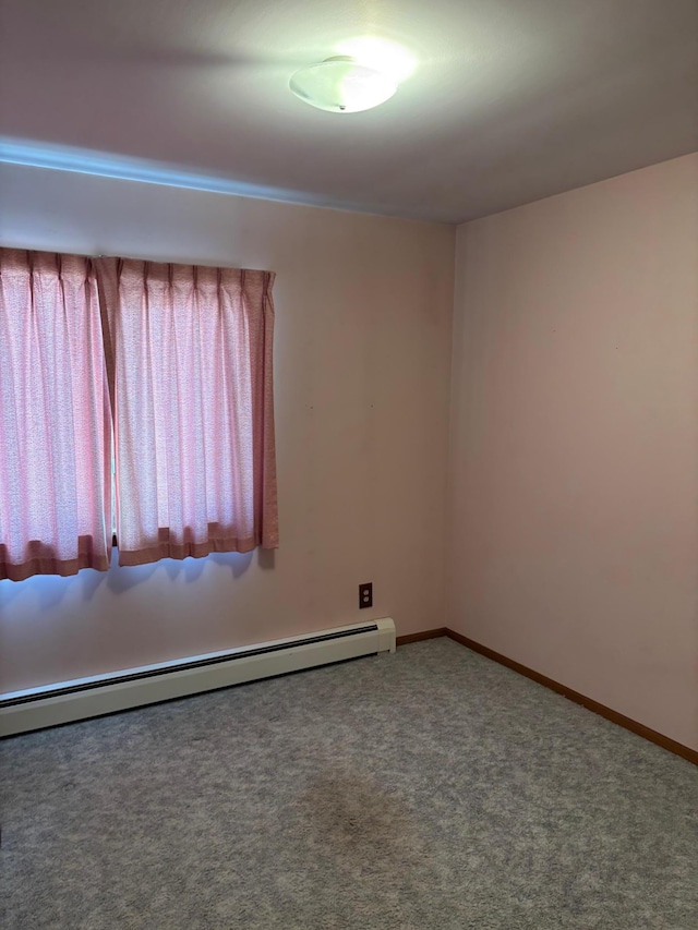 empty room featuring a baseboard radiator, baseboards, and carpet flooring