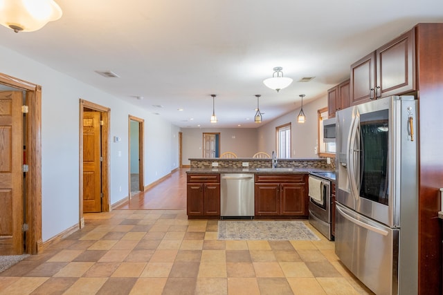 kitchen featuring a sink, stainless steel appliances, a peninsula, and visible vents