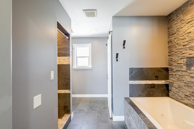 full bathroom with a tile shower, visible vents, baseboards, and a whirlpool tub