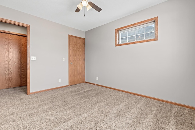 unfurnished bedroom featuring baseboards, carpet, and a ceiling fan