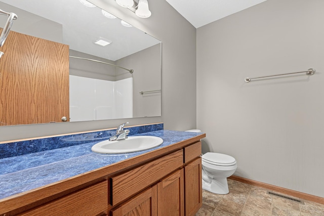 full bathroom with vanity, baseboards, visible vents, walk in shower, and toilet