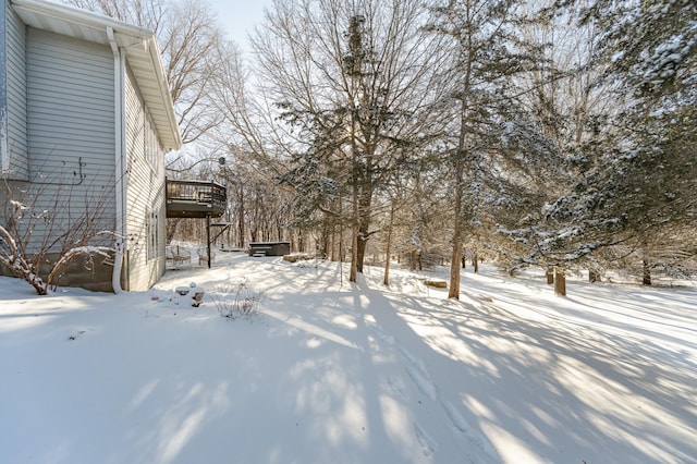 yard covered in snow with a wooden deck