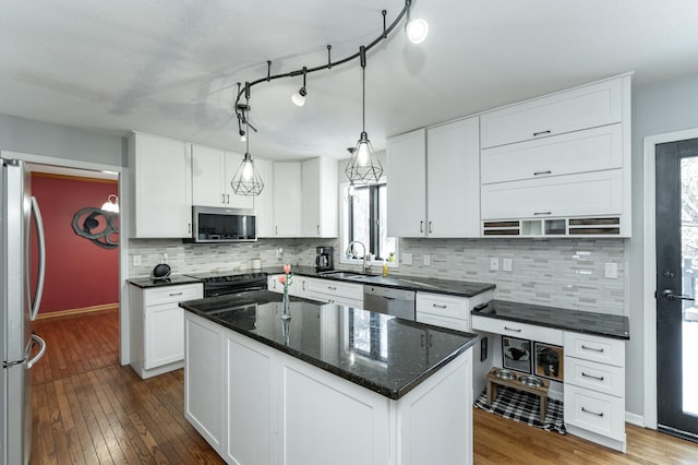 kitchen featuring a sink, appliances with stainless steel finishes, and white cabinetry