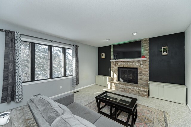 living area with visible vents, baseboards, carpet, and a brick fireplace