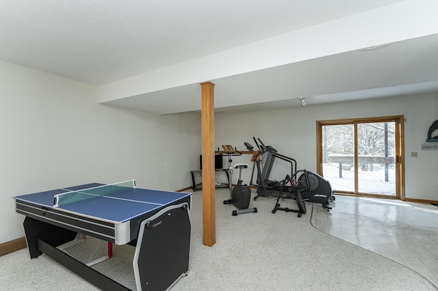 game room with tile patterned floors, a textured ceiling, and baseboards