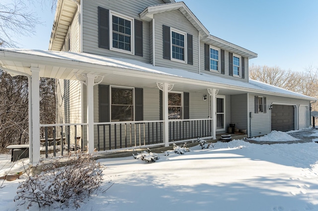 view of front facade featuring a porch and a garage