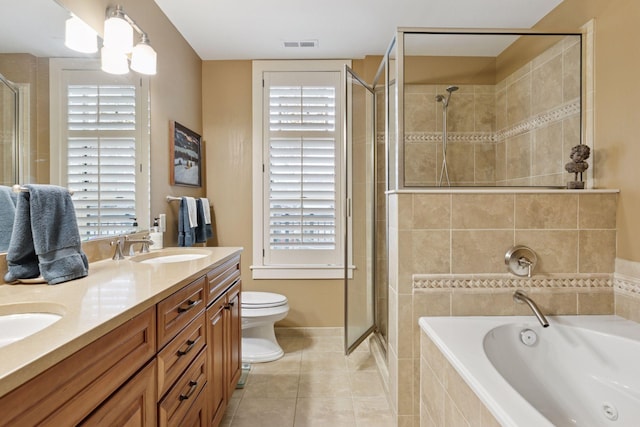 bathroom with tile patterned flooring, visible vents, a shower stall, toilet, and a sink