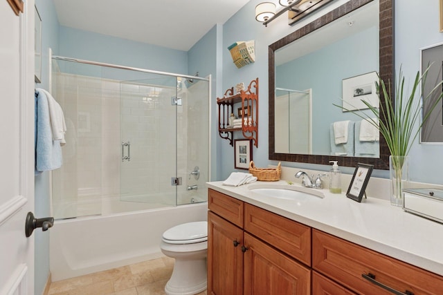 bathroom with enclosed tub / shower combo, tile patterned flooring, toilet, and vanity