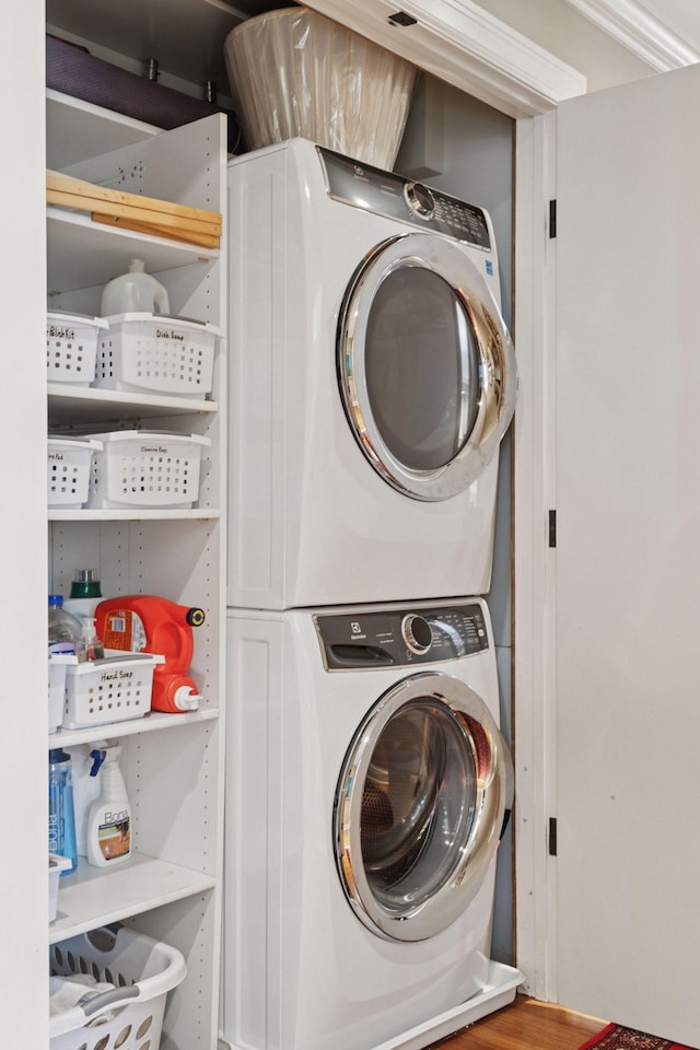 clothes washing area featuring laundry area and stacked washer / drying machine