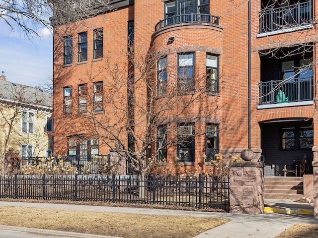 view of building exterior with fence