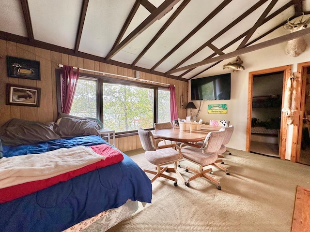 bedroom featuring vaulted ceiling with beams, carpet flooring, and wood walls