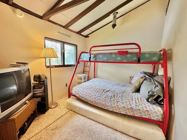 carpeted bedroom with lofted ceiling with beams