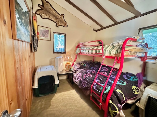 carpeted bedroom featuring vaulted ceiling with beams