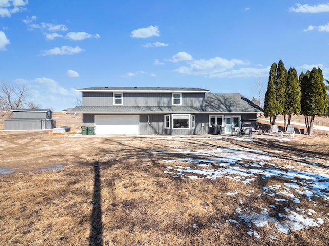 view of front of home with an attached garage and dirt driveway